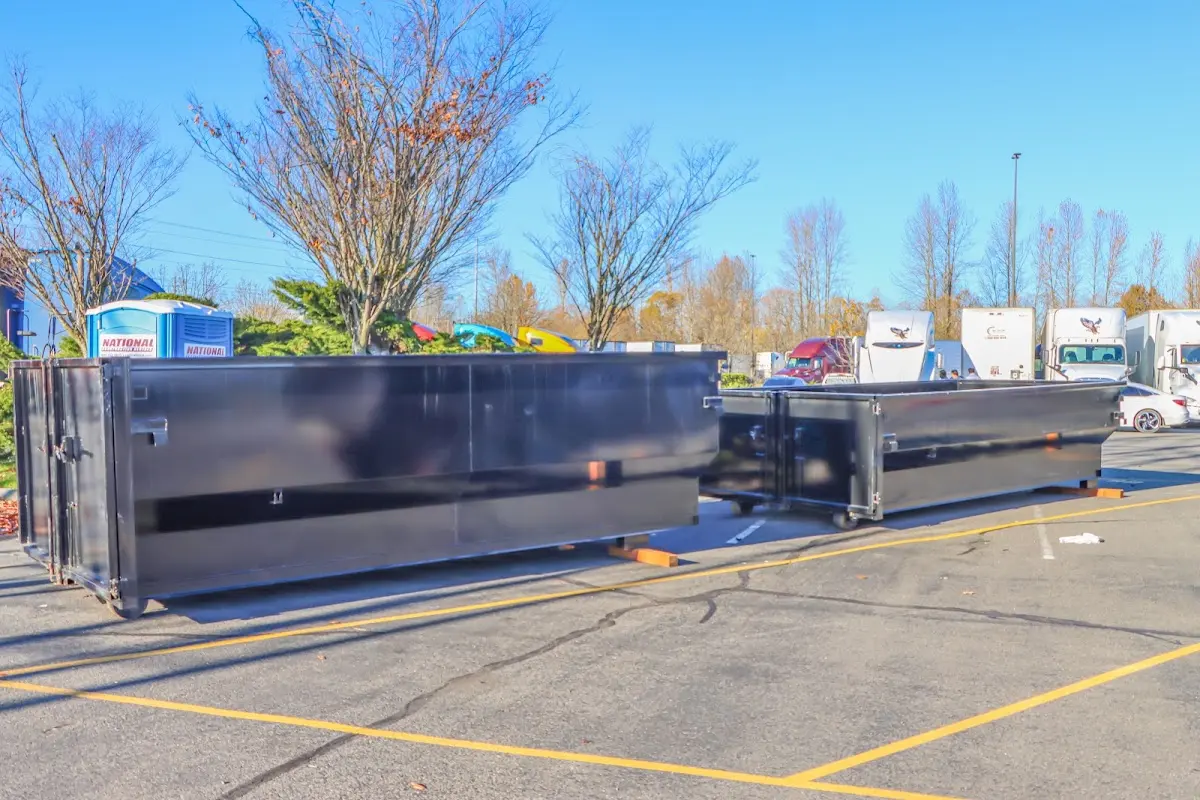 Professional dumpster rental service with roll-off container on residential driveway in South Windsor